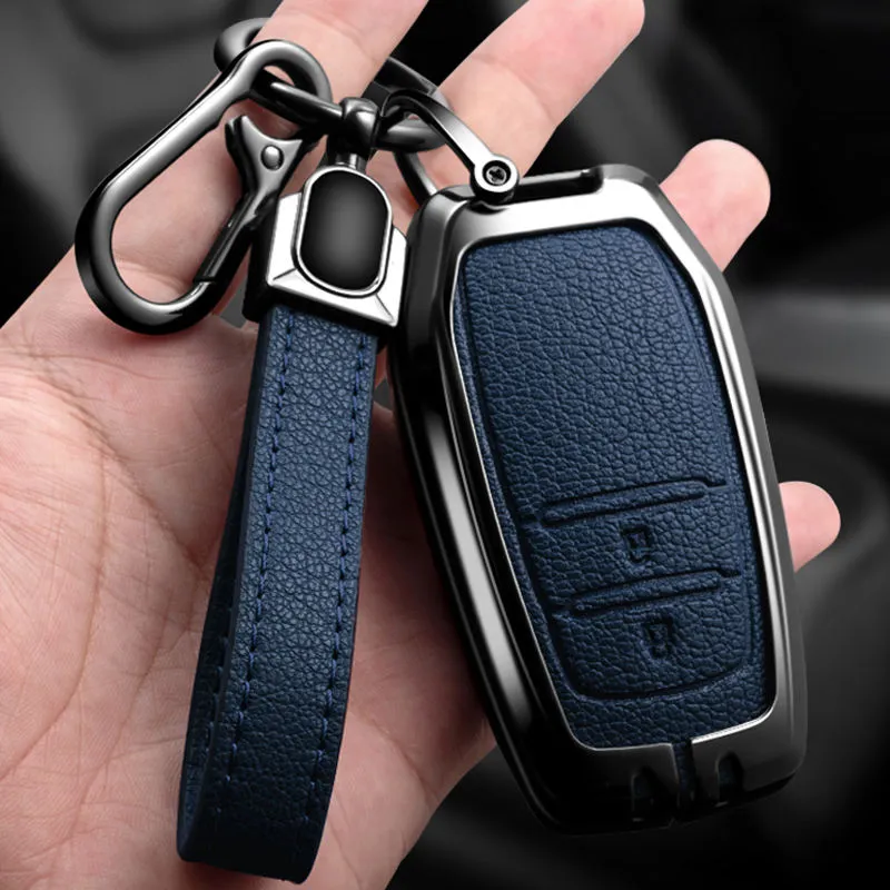 Hand holding a Keyvane armor key fob cover in navy blue with keychain